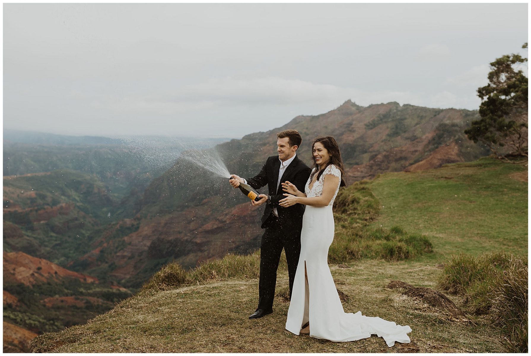 bride and groom sharing an intimate ceremony during their elopement on the cliffs of Waimea Canyon in Kauai, Hawaii 