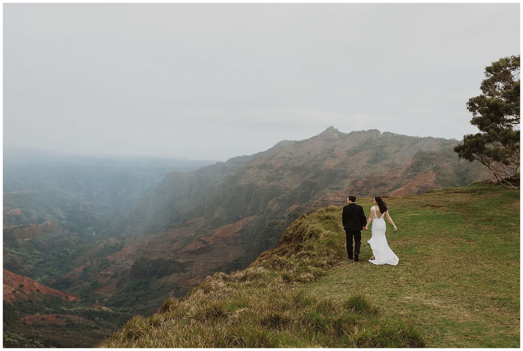 bride and groom sharing an intimate ceremony during their elopement on the cliffs of Waimea Canyon in Kauai, Hawaii 