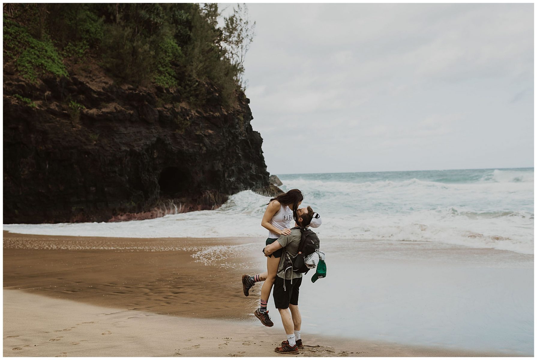 bride and groom hiking during their adventurous elopement on the cliffs of Waimea Canyon in Kauai, Hawaii 