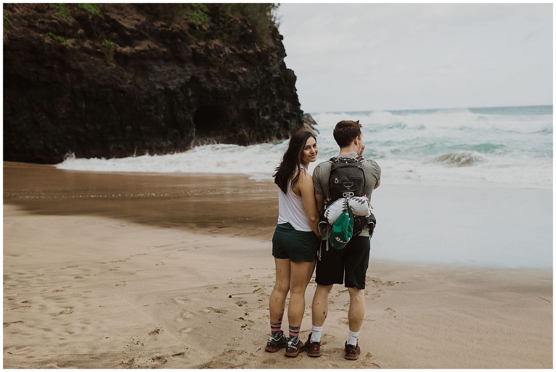 bride and groom hiking during their adventurous elopement on the cliffs of Waimea Canyon in Kauai, Hawaii 