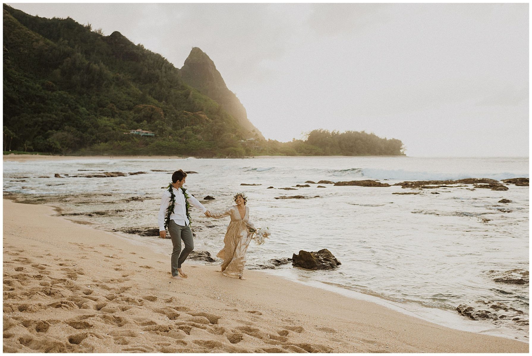 bride dressed in a gold dress holding hands with her groom, dressed in Hawaiian attire during their elopement on the beach of Kauai