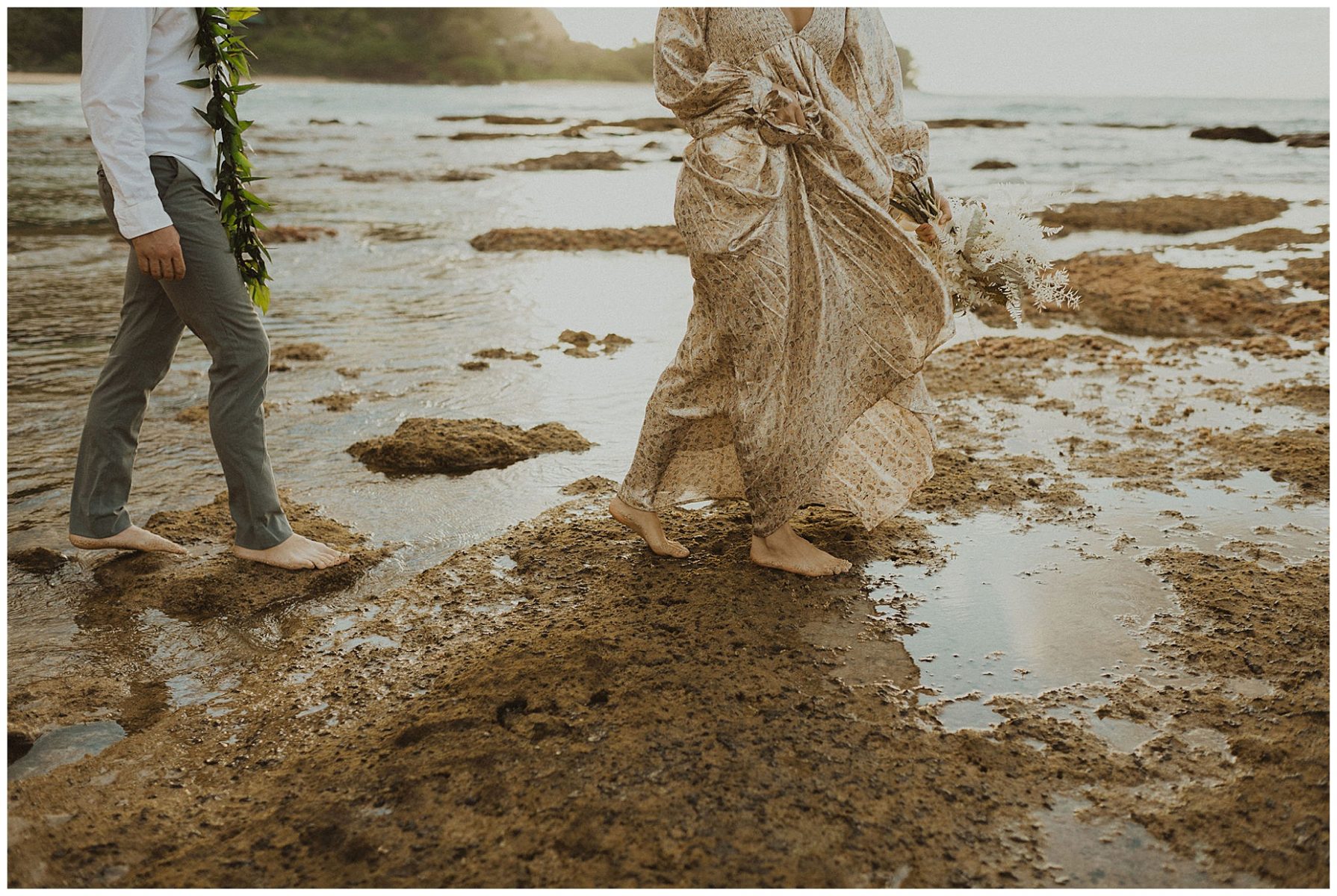 bride dressed in a gold dress holding hands with her groom, dressed in Hawaiian attire during their elopement on the beach of Kauai