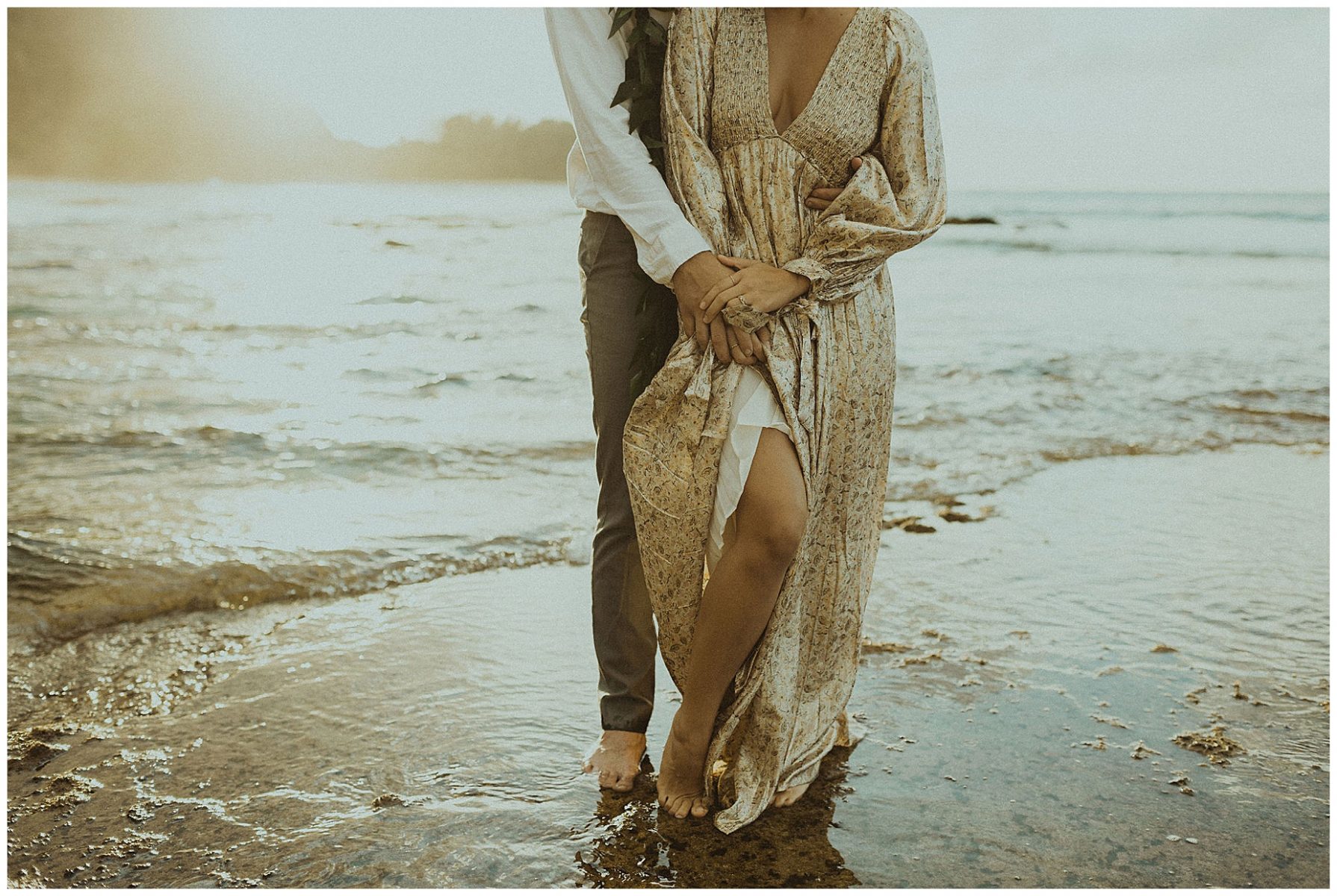 bride dressed in a gold dress holding hands with her groom, dressed in Hawaiian attire during their elopement on the beach of Kauai